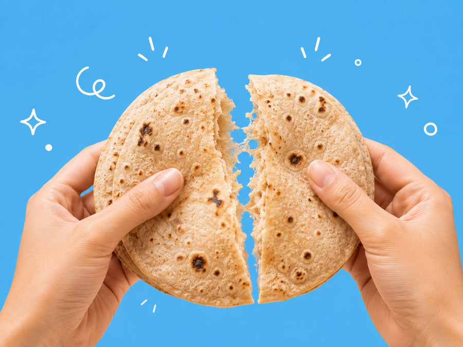 Hands breaking apart a soft, fluffy MillD roti
