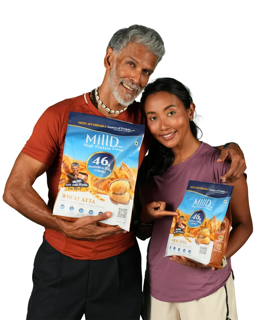 Milind Soman and Ankita Konwar holding MillD High Protein Atta 