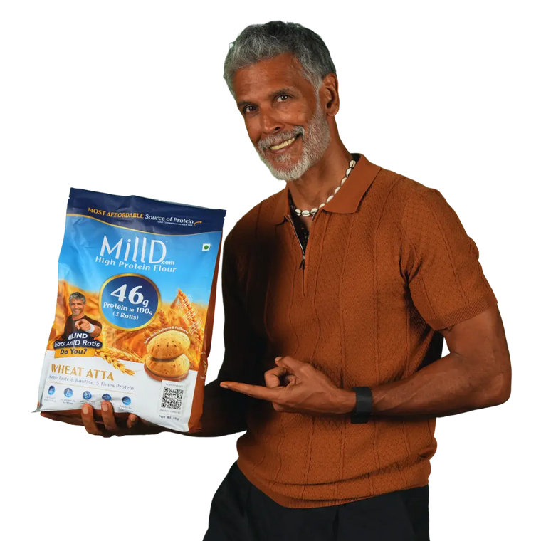 Milind Soman holding MillD High Protein Atta with 46g protein per 100g 