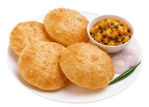Four golden-brown crispy fried Indian snacks called puris made with Milld high protein atta on a white plate, served with a small bowl of chutney, sliced red onion, and a green chili on a white background.